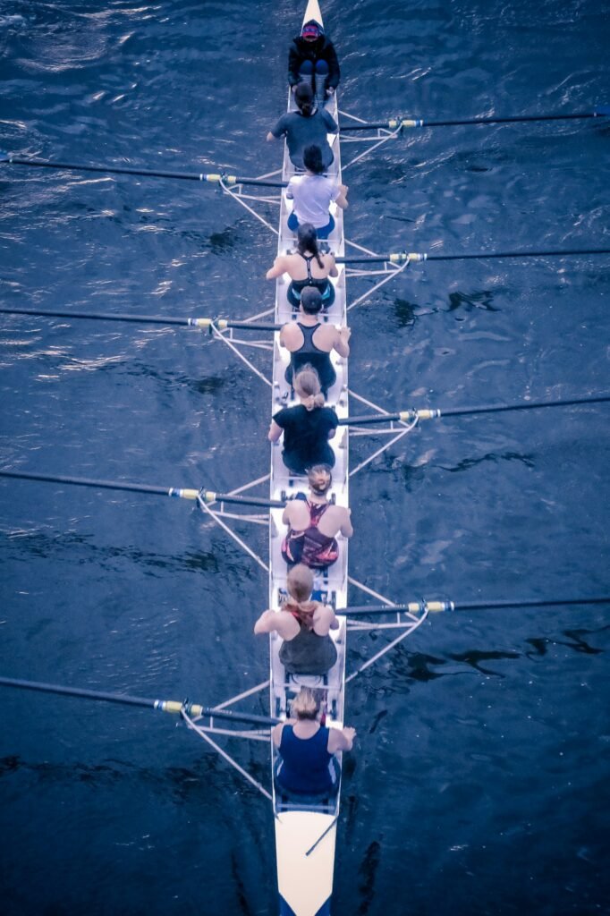 A female eight rowing team, training on the River Thames, London.