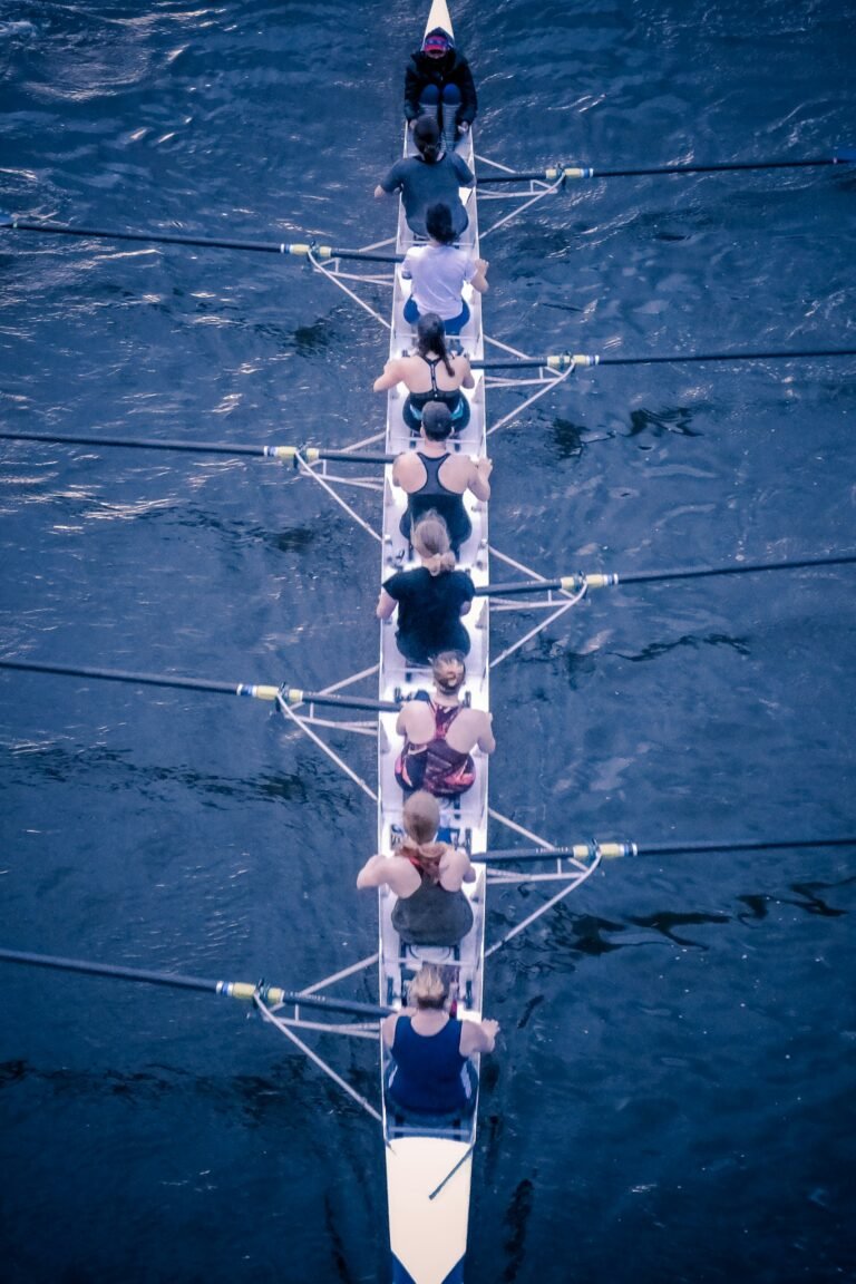 A female eight rowing team, training on the River Thames, London.