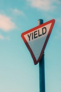 a yield sign with a sky background